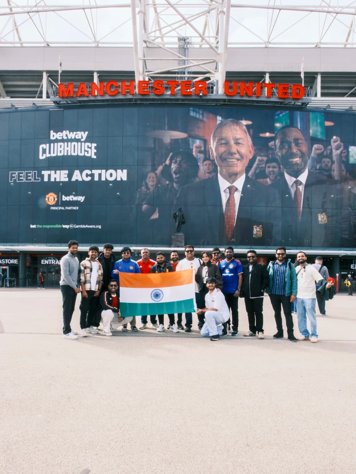 Standing before Best, Law, and Charlton outside the Theatre of Dreams.